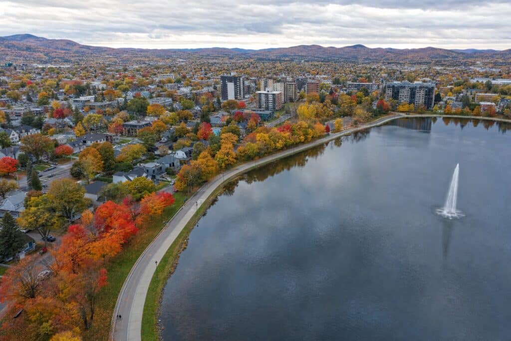 City lake with a fountain and autumn trees in the Eastern Townships